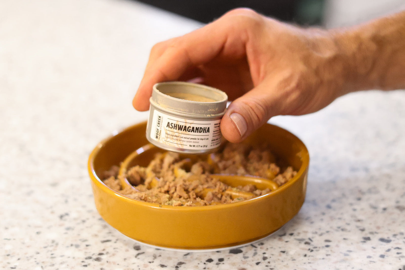 Ashwagandha natural supplement for dogs and cats stress support over pet food bowl
