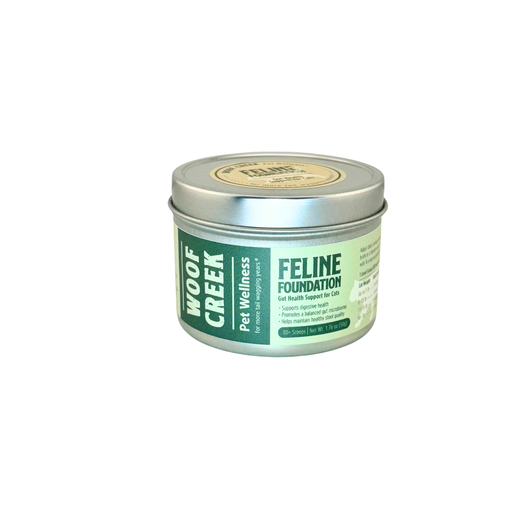Woof Creek Feline Foundation tin, angled view showing the full label with gut health support claims for cats
