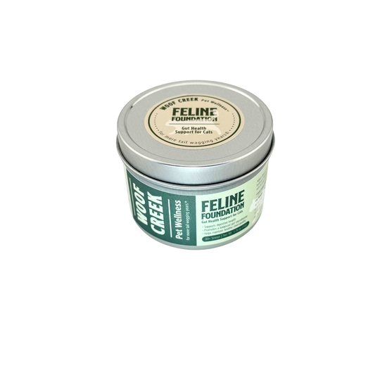 Woof Creek Feline Foundation tin, top-down angle showing the round lid label