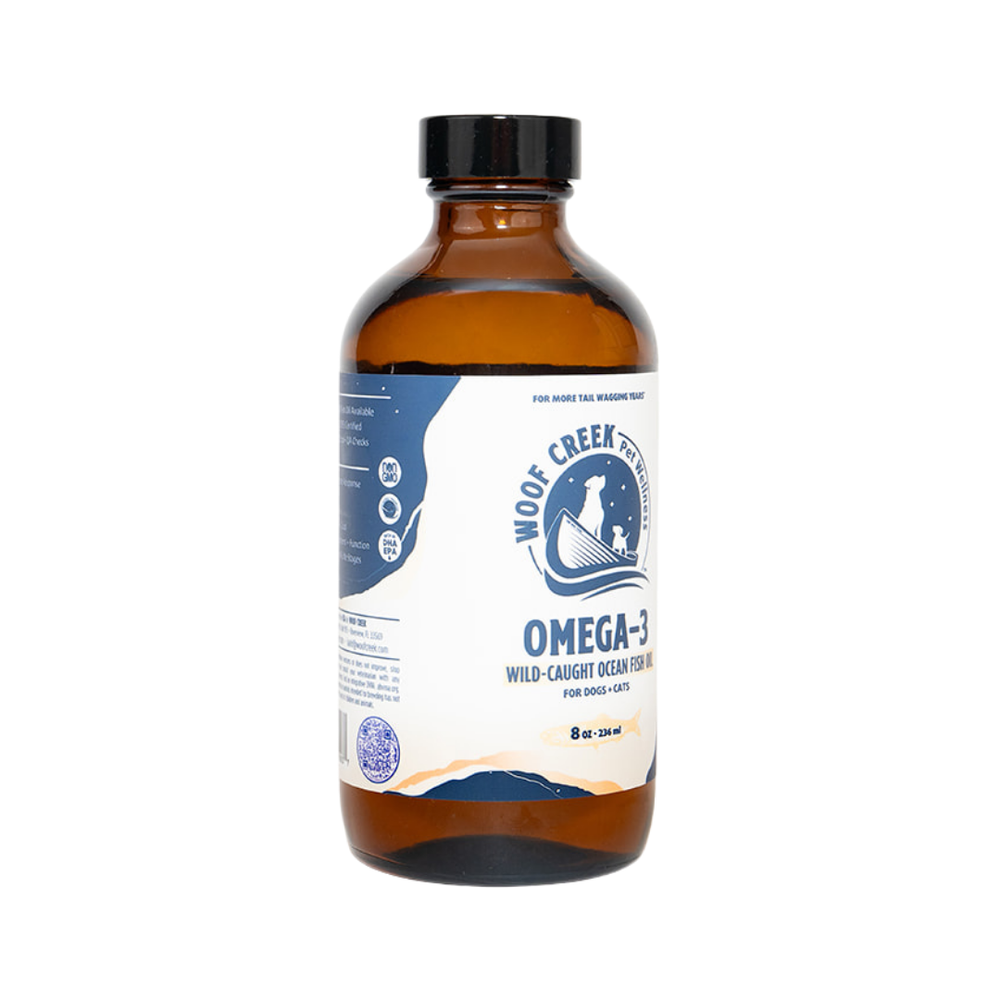 Omega-3 Ocean Fish Oil in a glass bottle for dogs and cats, part of Woof Creek Dog Wellness superfoods, showing the product label.