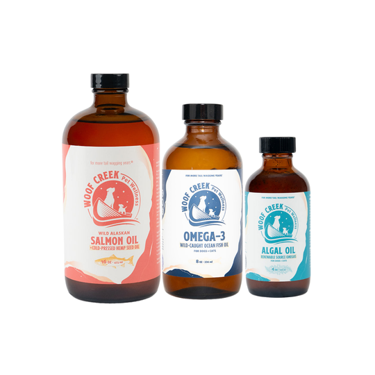 Bottle of Omega DHA and EPA oil bundle for cats from Woof Creek Pet Wellness, featuring natural oils in dropper bottles.