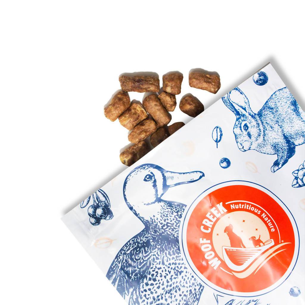 natural duck dog treats spilling from the bag to show texture. Small dog treats. puppy training treats