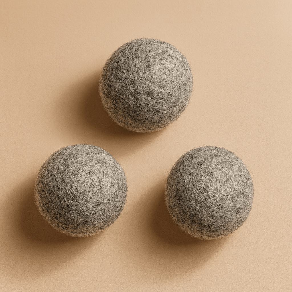 Three organic wool dryer balls from Zero Waste Outlet, eco-friendly laundry accessory for softer, static-free clothes.