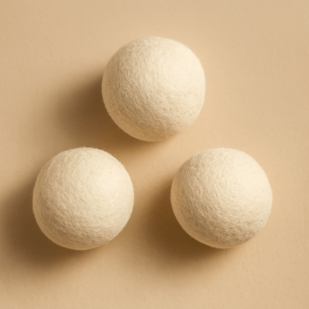 Set of three organic wool dryer balls from Zero Waste Outlet, natural laundry fabric softener and eco-friendly dryer accessory.