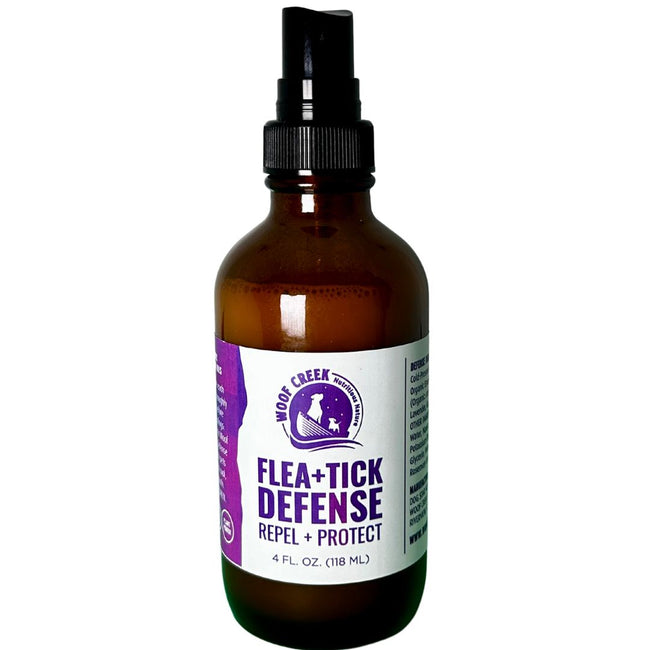 All-natural flea and tick defense spray for dogs and cats by Woof Creek Dog Wellness, 4 fl oz bottle with spray nozzle.